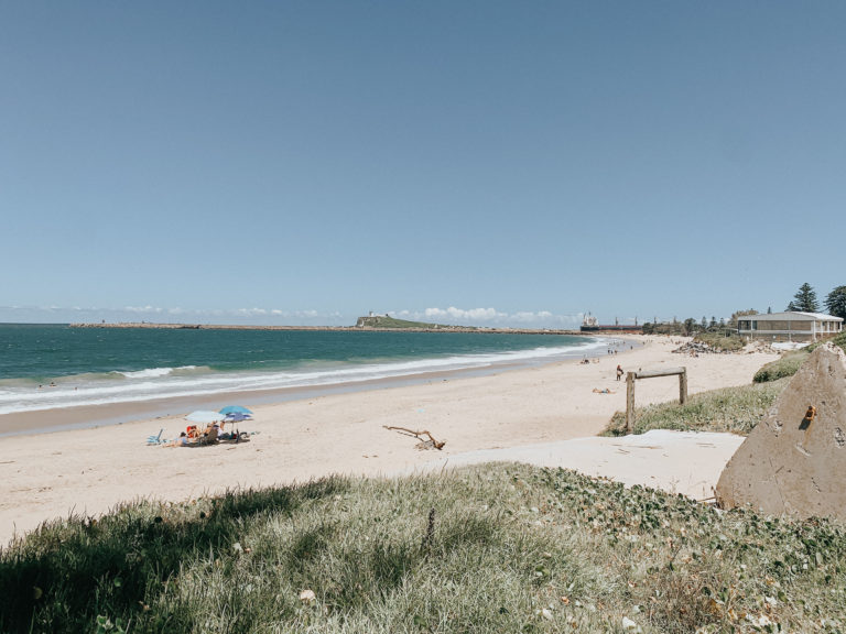 Graphic designer Newcastle picture of Stockton beach facing Nobby's Head Lighthouse